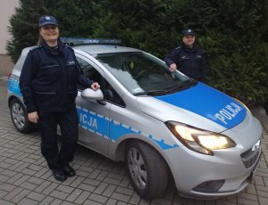 na zdjęciu widać dwoje umundurowanych policjantów przy radiowozie oznakowanym