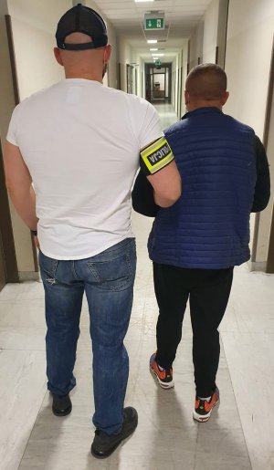 Policjant z zatrzymanym mężczyzną