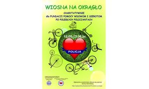Zdjęcie przedstawia żółty plakat z kolorowym kołem wewnątrz zawierający czerwone serce z niebieskim napisem Policja.