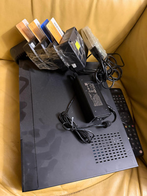 Zdjęcie przedstawia dekoder z kartami i pilot do niego.