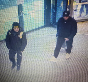 Zdjęcie przedstawia dwóch ubranych na ciemno mężczyzn.